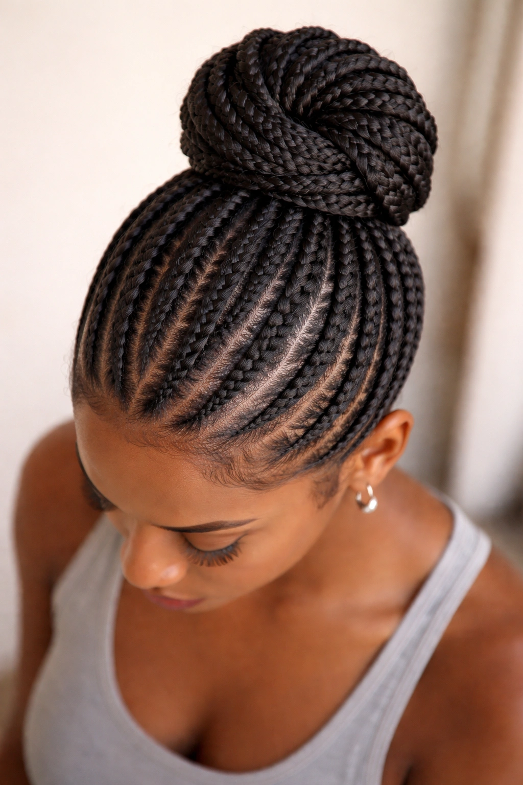 Knotless cornrows gathered into a high bun updo