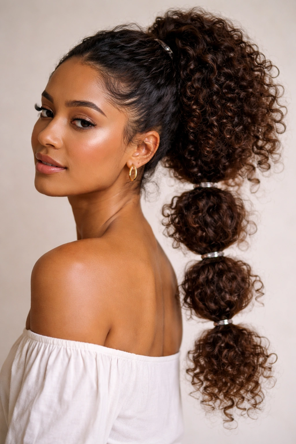 Bubble ponytail with textured curls and multiple ties