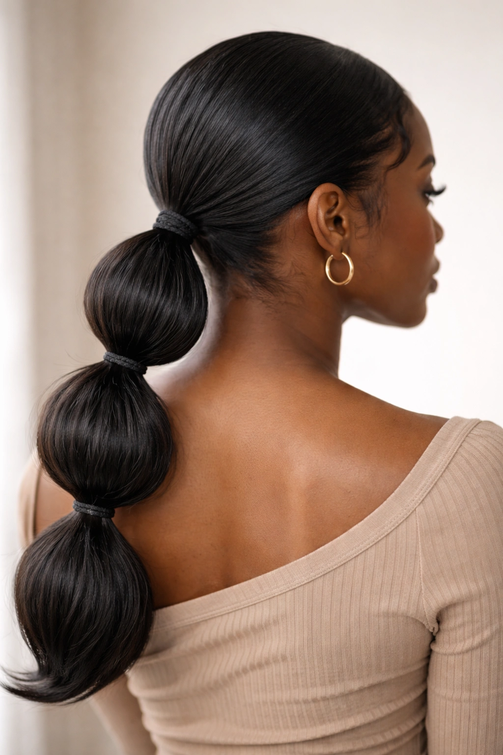 Low bubble ponytail with 2-3 bubble sections along the length
