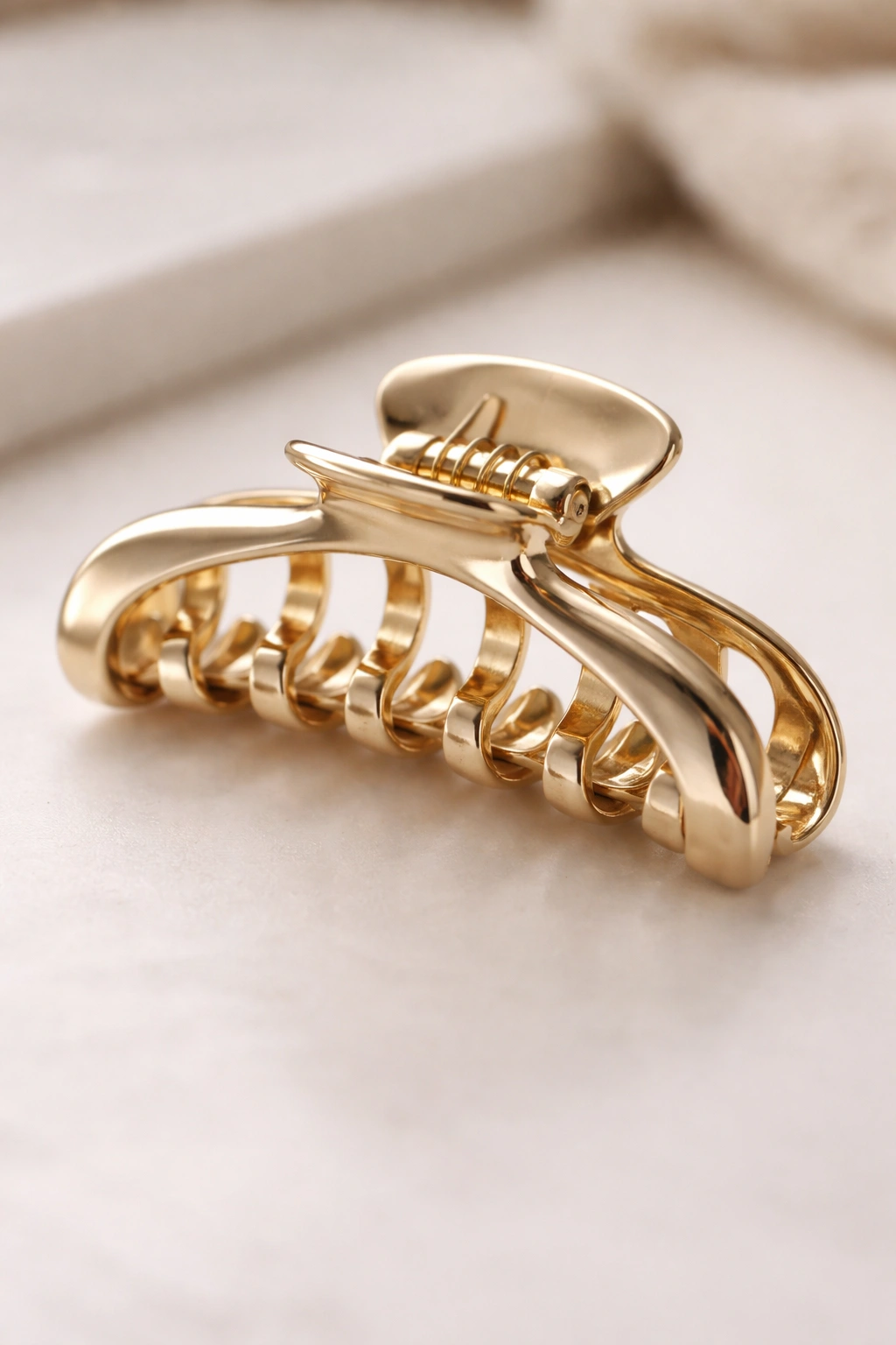 Close-up of a claw clip on a clean surface highlighting its condition