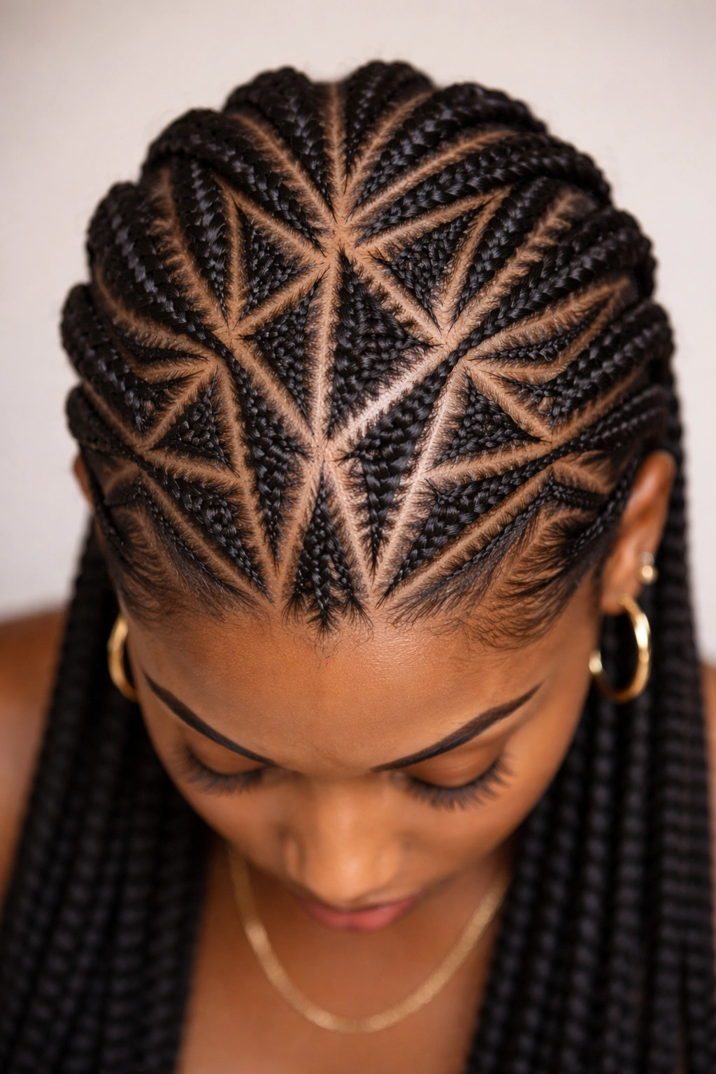 Close-up of cornrows forming geometric patterns on the scalp