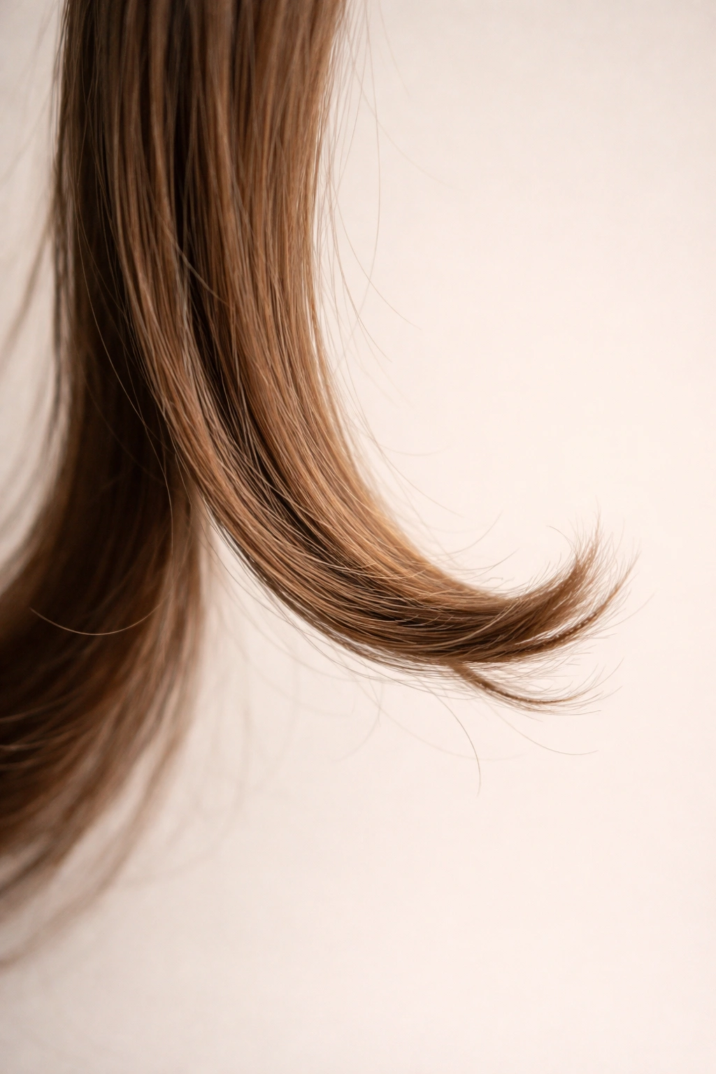 Hair strand with an imperfect curled end illustrating curling mistakes