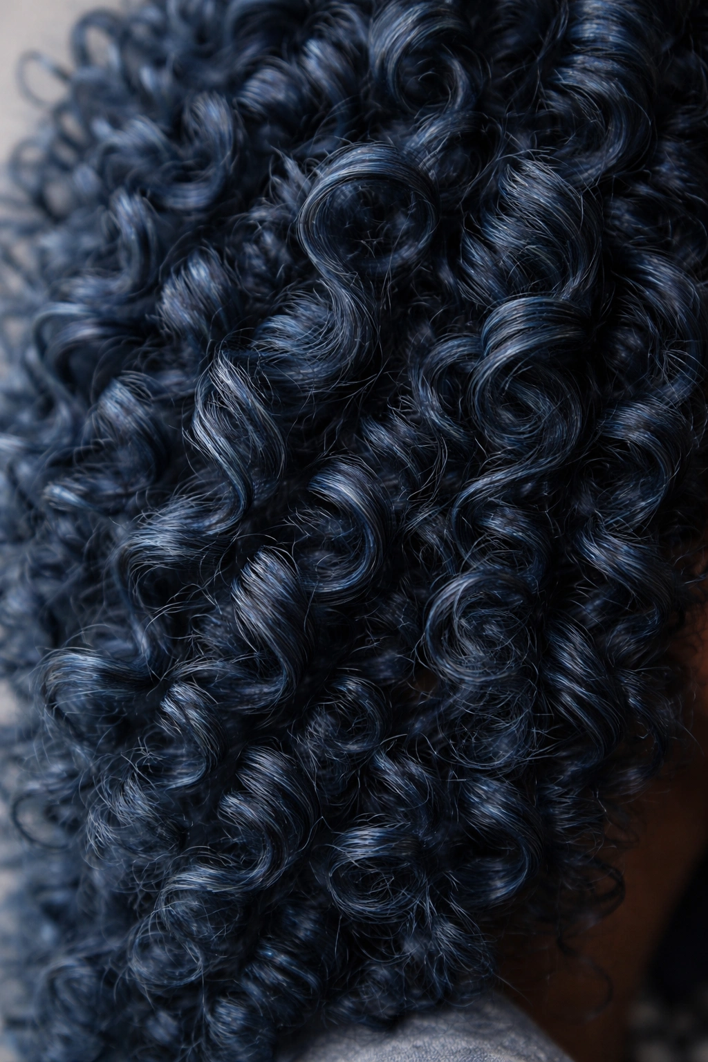 Denim blue coily hair close-up showing depth and gray undertones