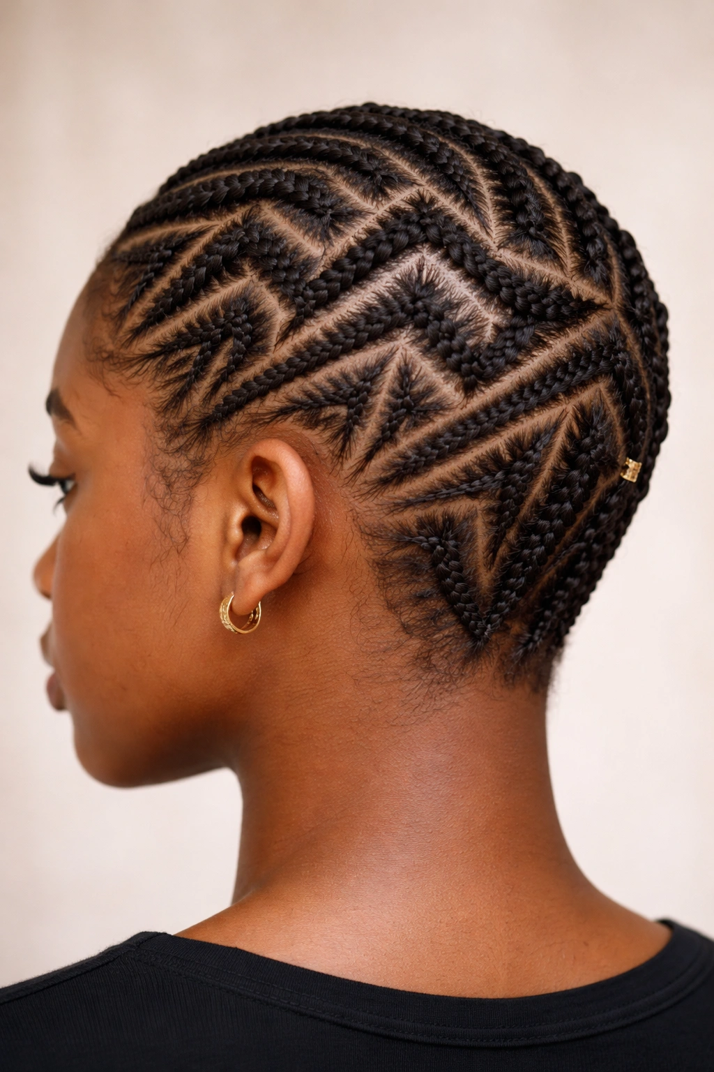 Close-up of zig-zag geometric braids on short hair, showcasing angular scalp patterns