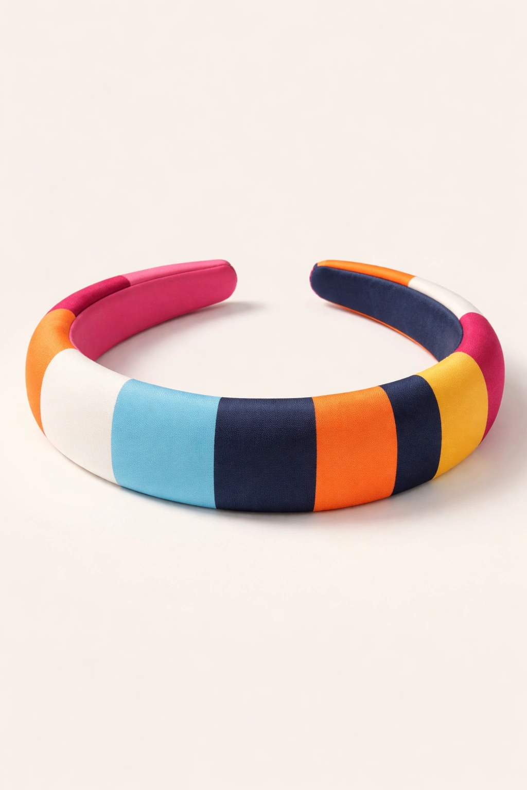 Geometric color-block headband with bold stripes on neutral background