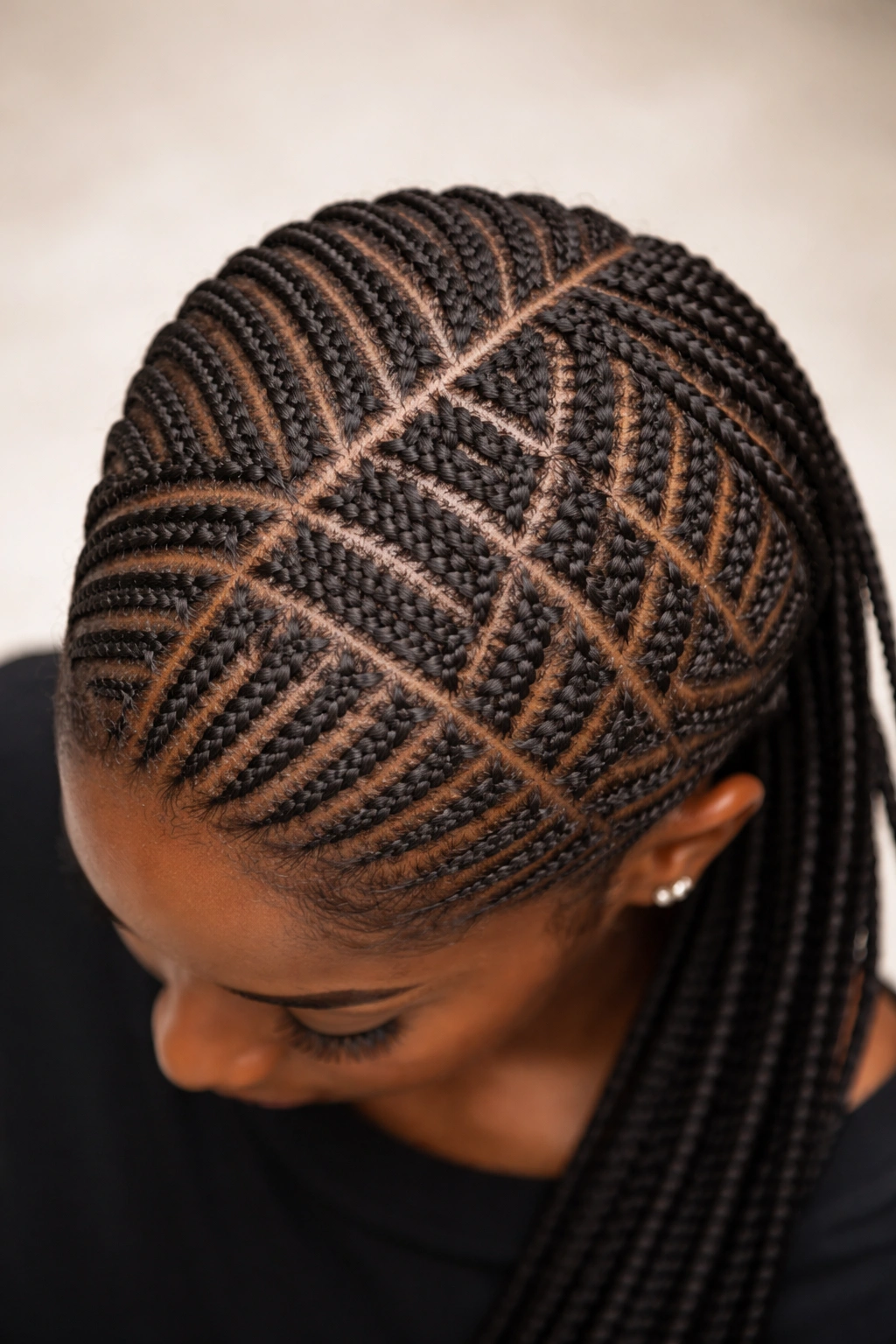 Close-up of a quilted grid of multi-directional cornrows across the scalp