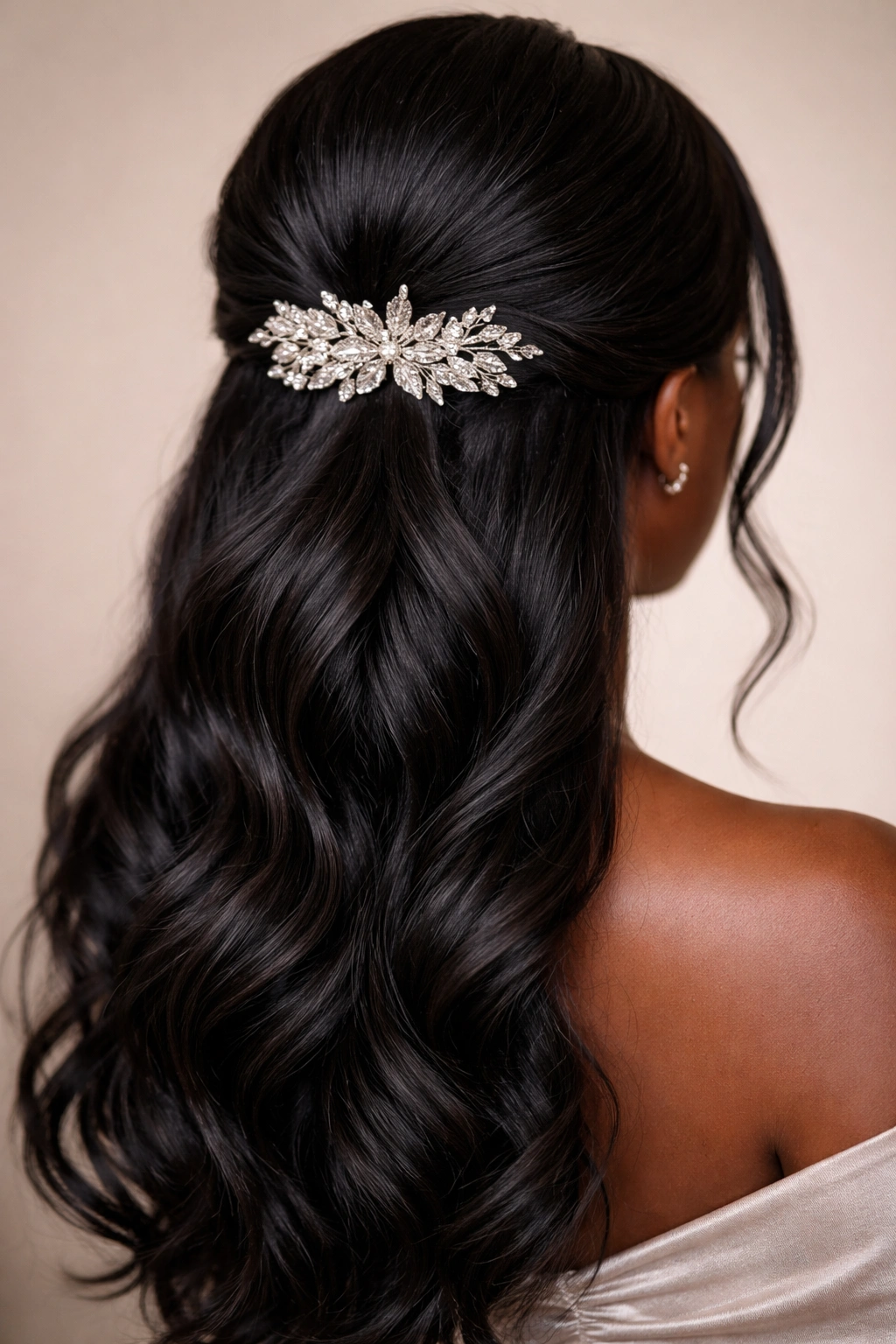 Close-up of a low half-up hairstyle at the nape with a jeweled hairpiece.