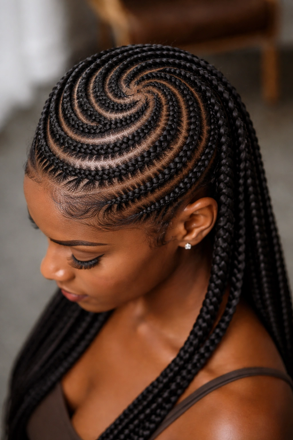 Spiral cornrows creating texture and depth on coily hair