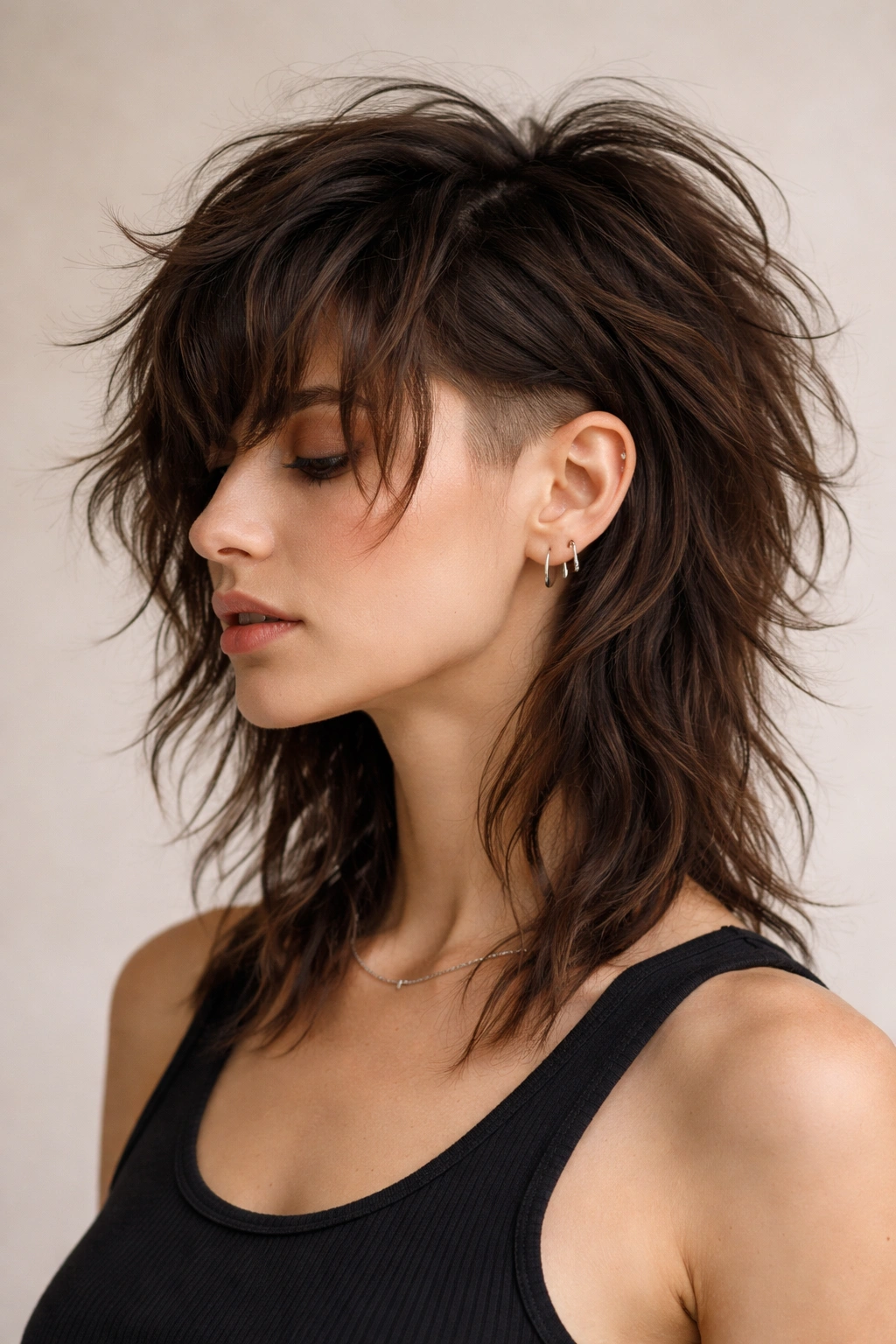 Close-up portrait of a person with a shag haircut featuring a dramatic undercut
