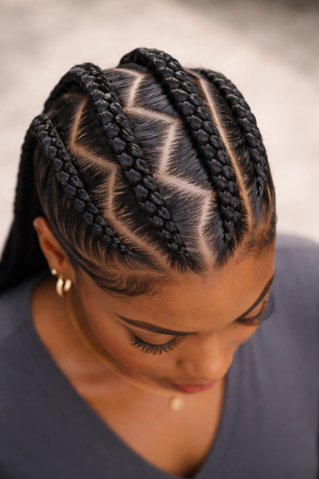 Three zigzag cornrows across the scalp