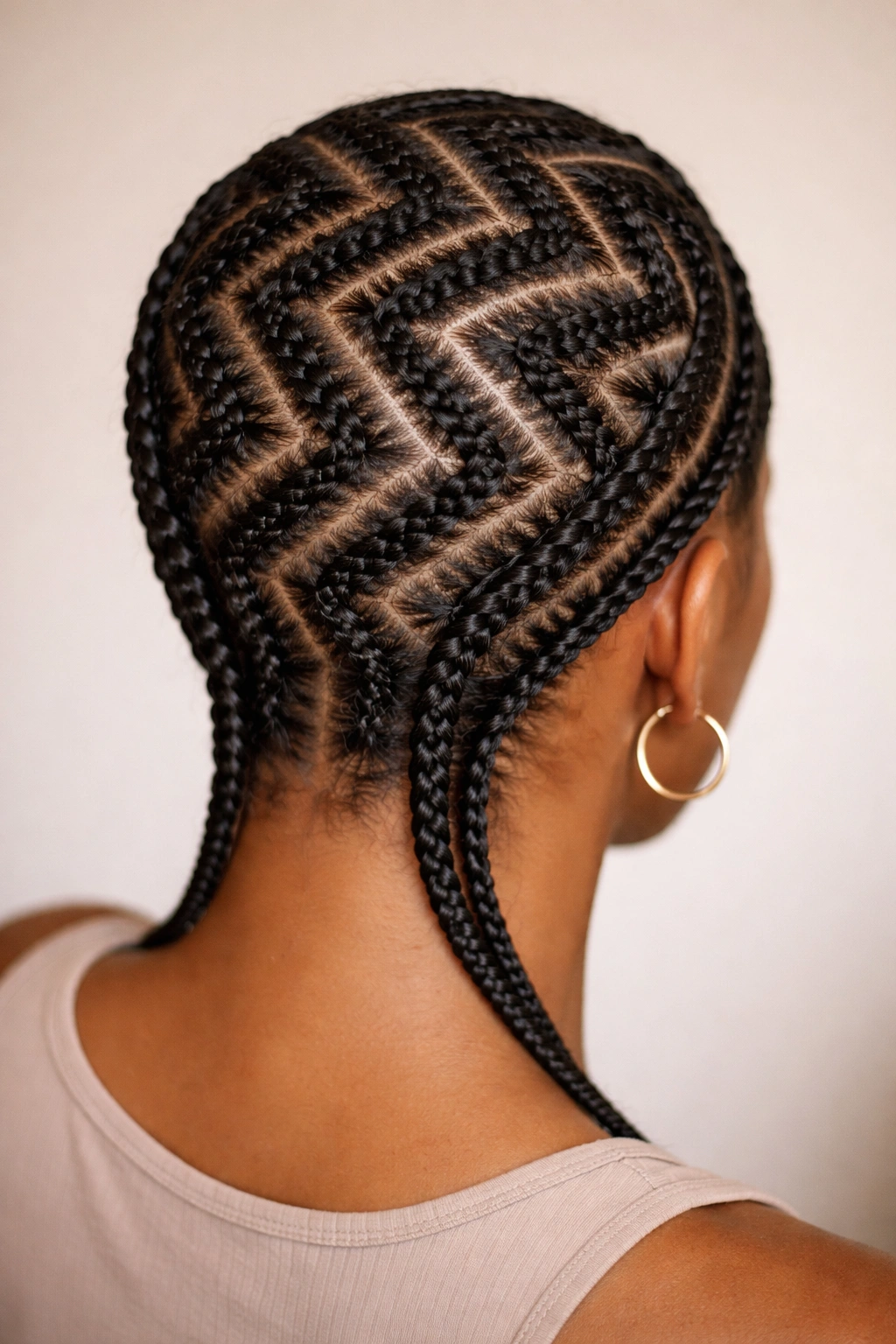 Zigzag cornrows creating a bold chevron pattern across the back of the head.