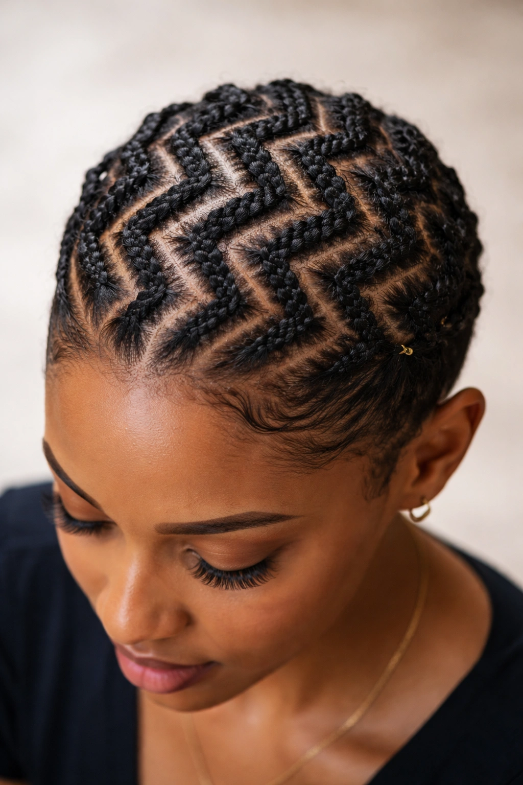 Zigzag cornrows pattern across the scalp on short natural hair.