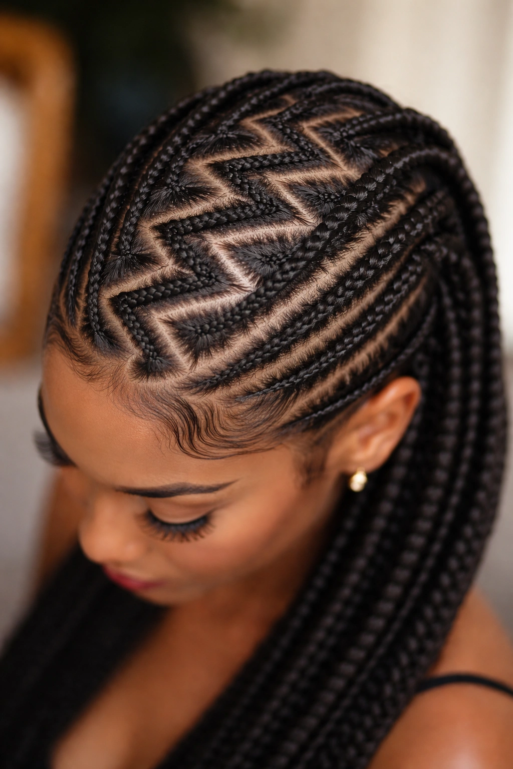 Top-down view of zigzag cornrows forming a geometric scalp pattern