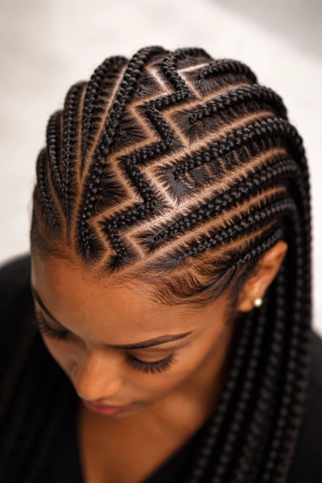 Top-down view of geometric zigzag cornrows across the scalp