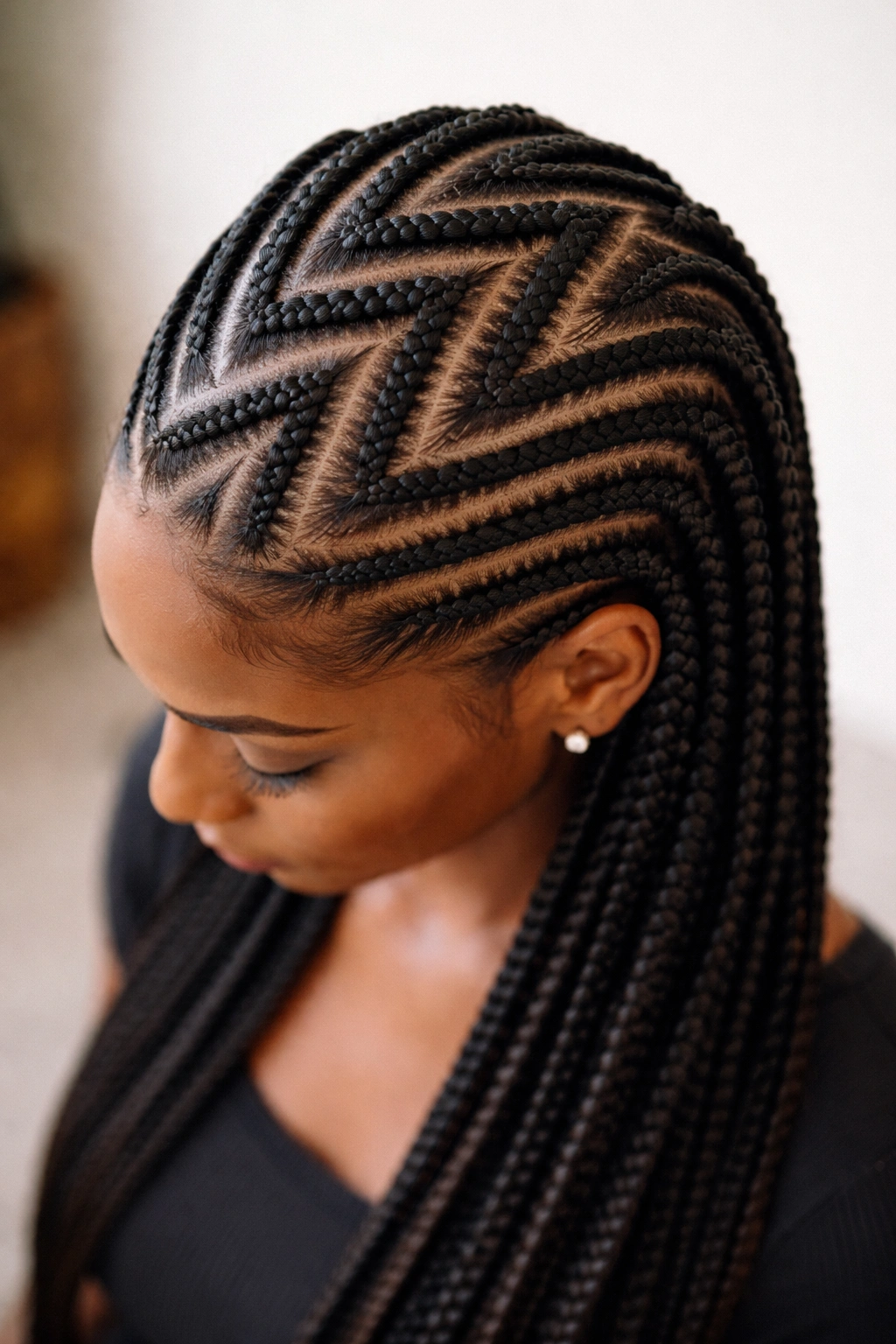 Top-down view of zigzag diagonal knotless cornrows forming a chevron pattern