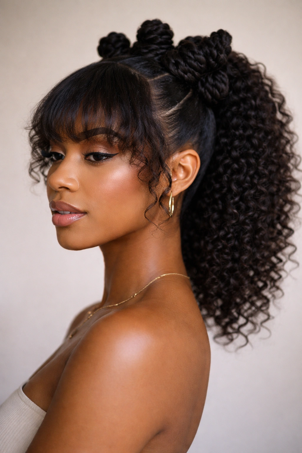 Bantu knot ponytail with tapered natural bangs showing taper and texture