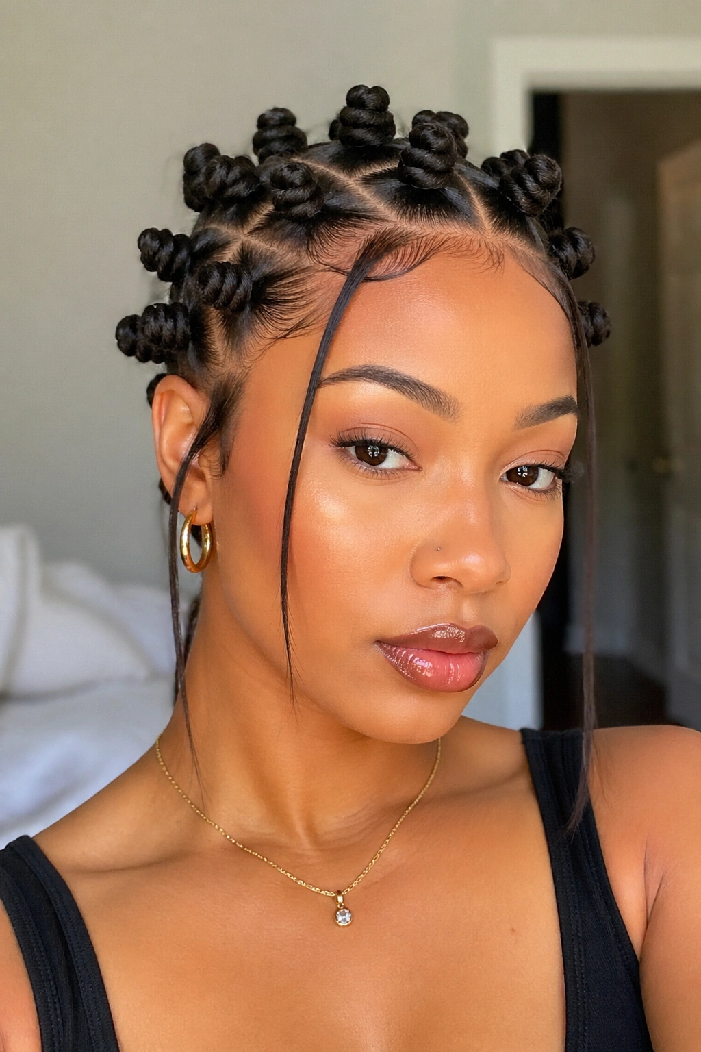 Real person with tapered face-framing Bantu knots