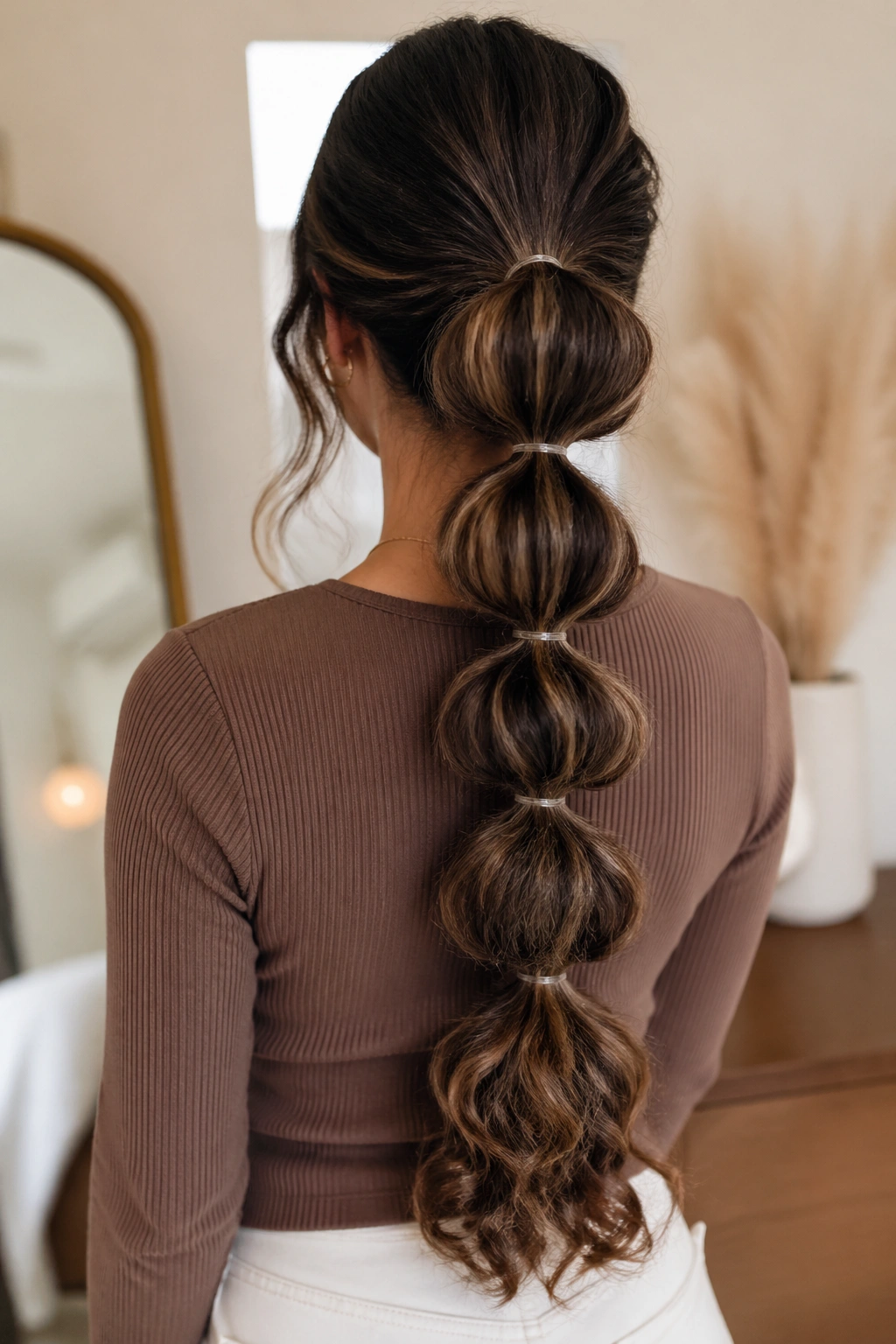 Rear view of a real woman with a bubble ponytail showing segmented sections