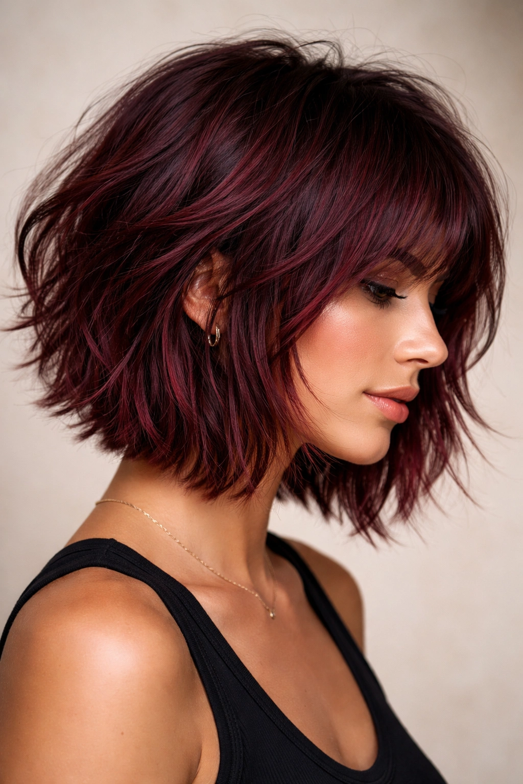 Textured burgundy shag bob with choppy layers and crown lift
