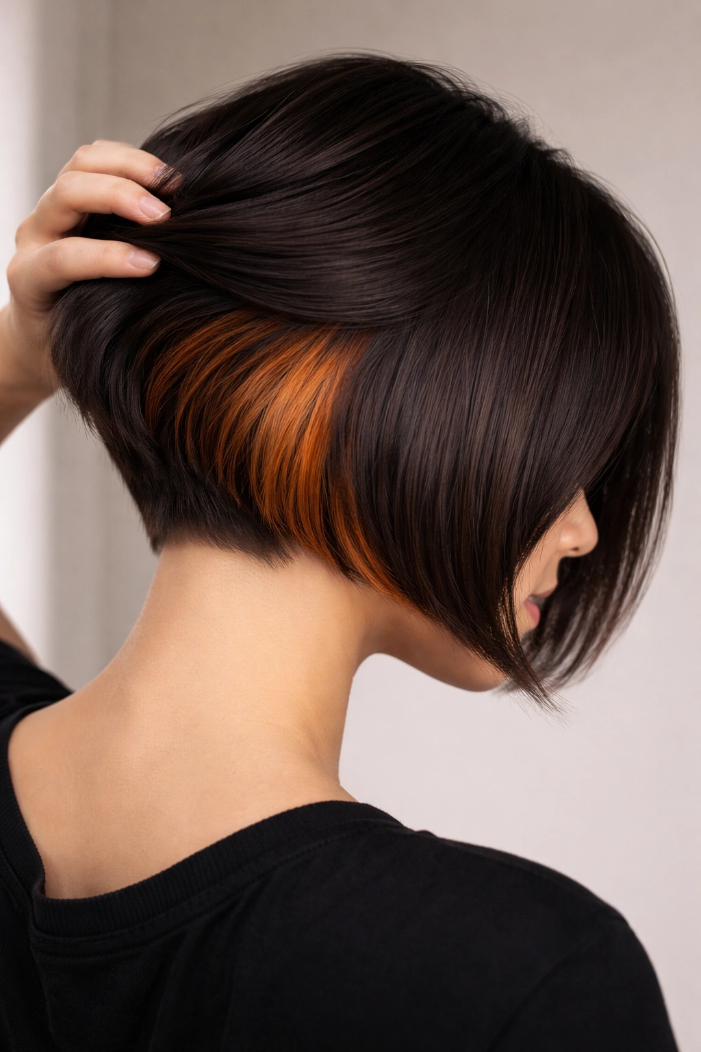 Color-contrast undercut bob with hidden color panel visible when hair moves