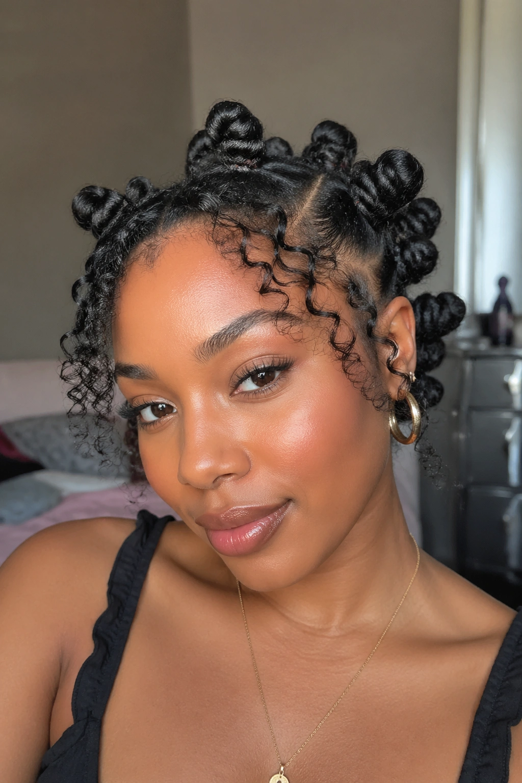 Woman with Bantu knots and curly ends left out