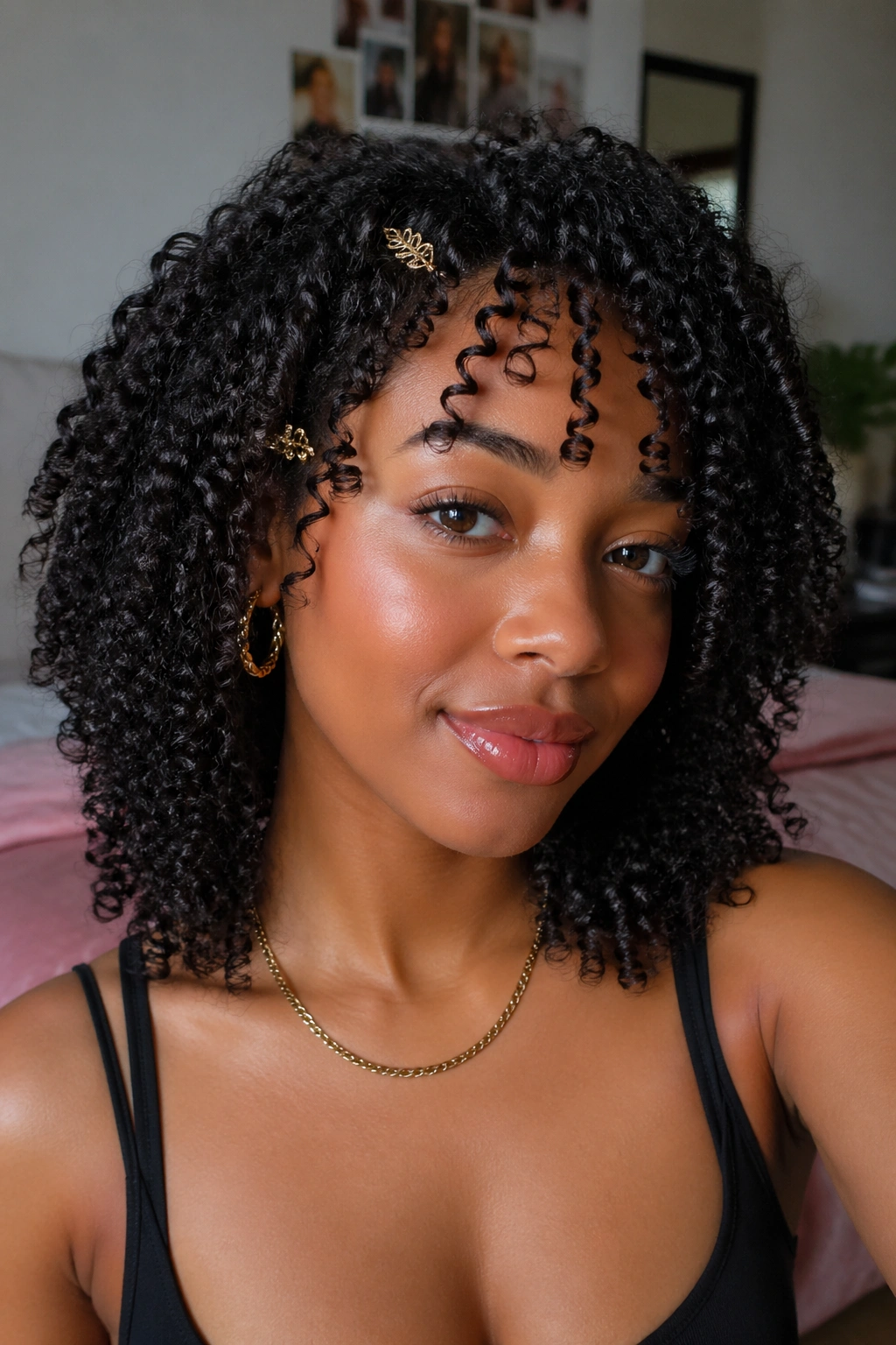 Close-up portrait of a real woman with defined curly wash-and-go and gold hair clips