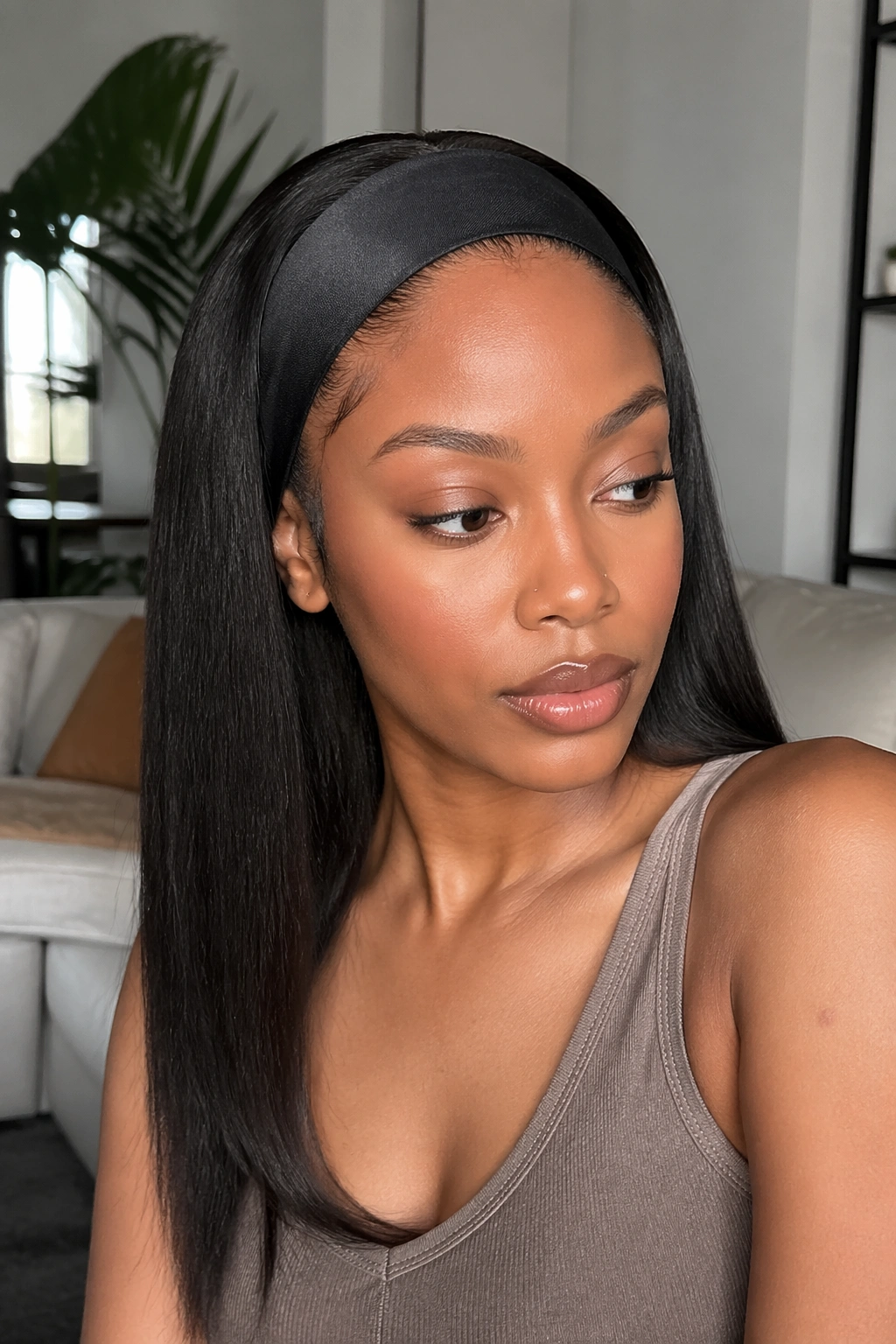 Close-up portrait of a real woman wearing a straight headband wig with smooth edges under warm window light