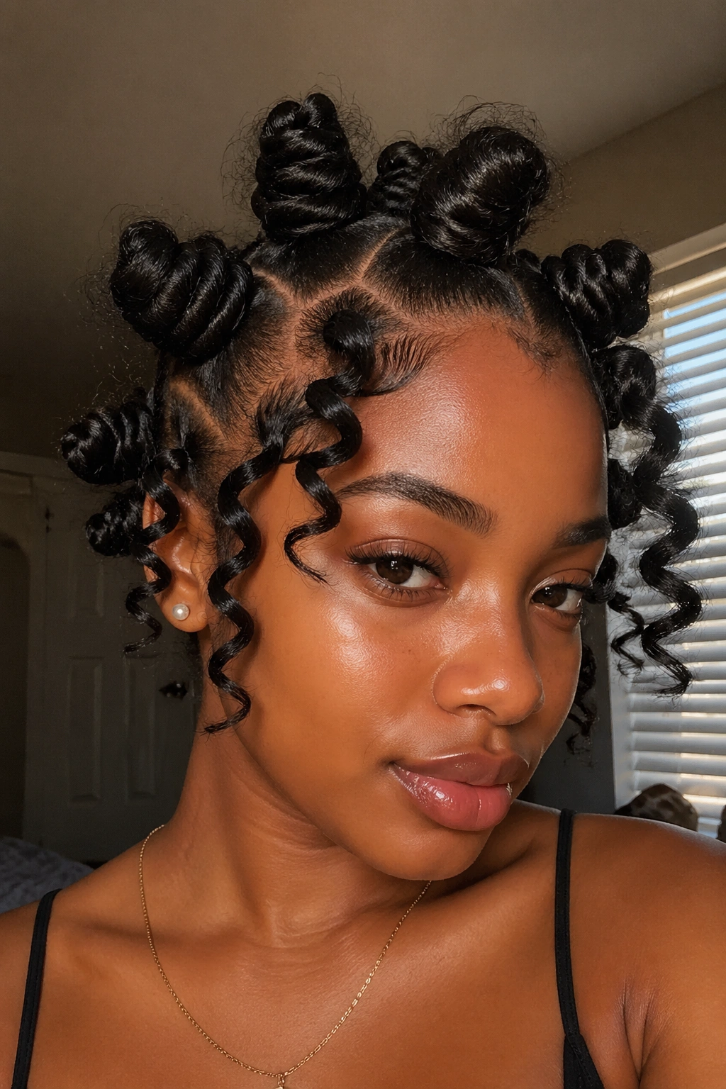 Close-up of jumbo crown Bantu knots with loose spiral ends on a real person