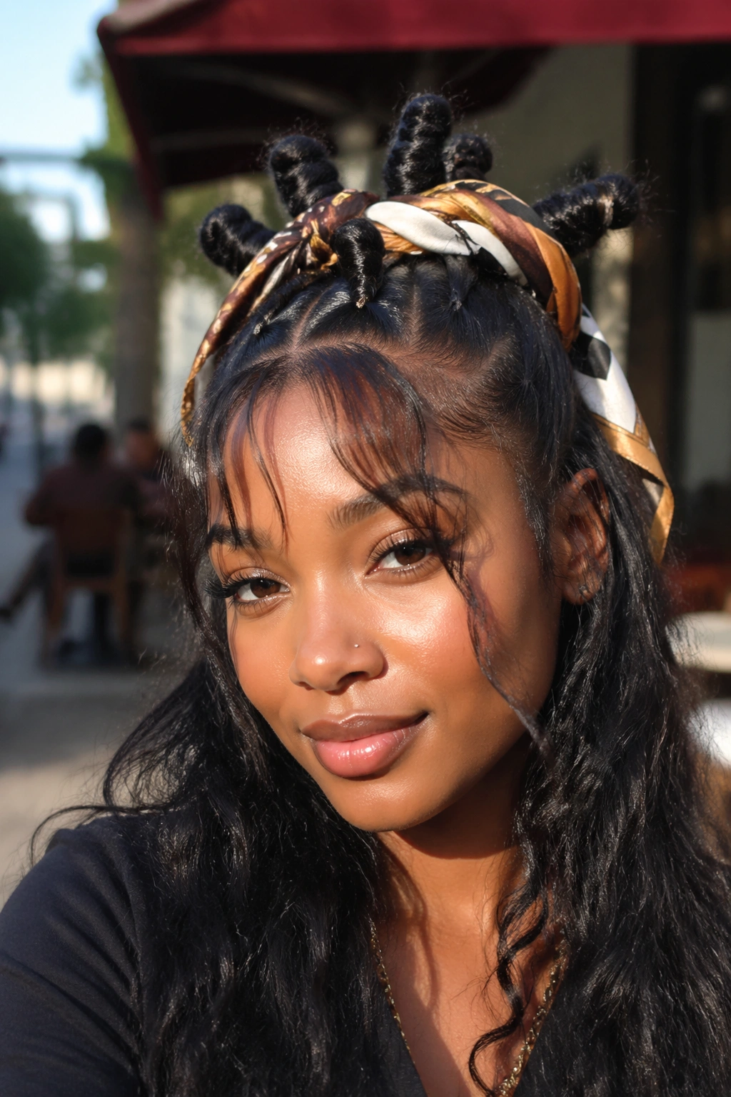 Real person wearing scarf-wrapped knots with wispy bangs in a cafe setting