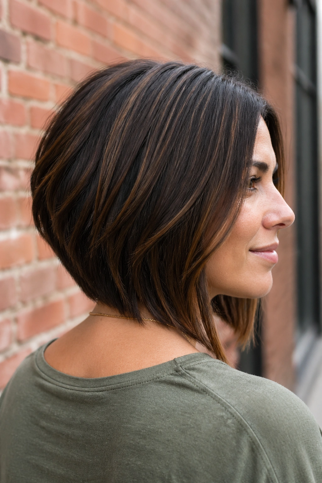 Close-up of a real woman with a stacked lob at the nape for thick hair.