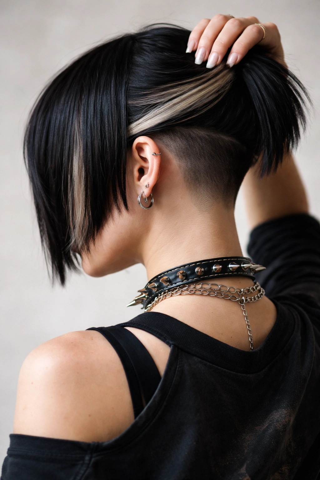 Undercut punk bob with hidden shave visible at nape when hair moves