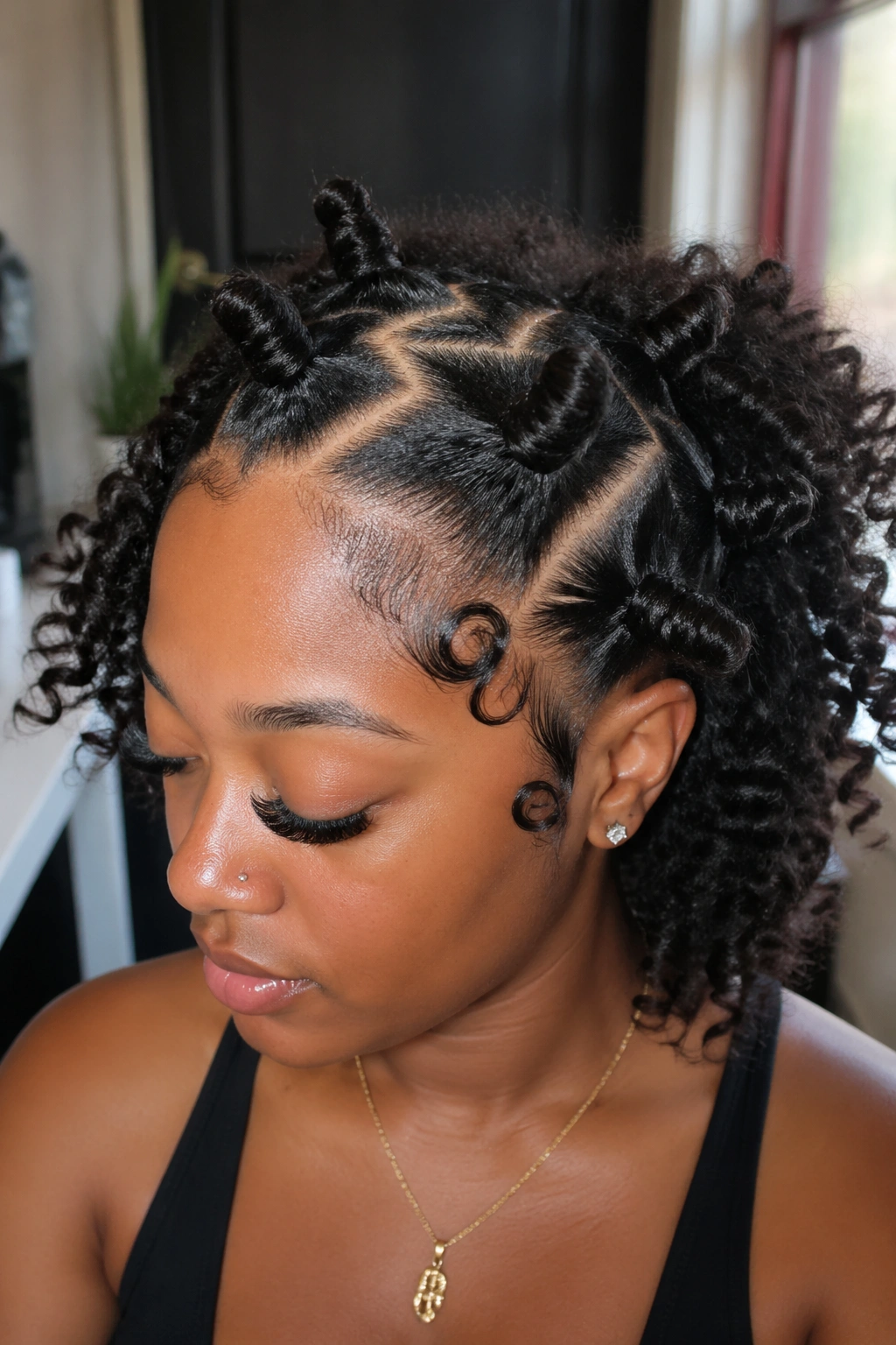 Close-up of a real person with Zigzag-Part Bantu Knots and fluffed curls