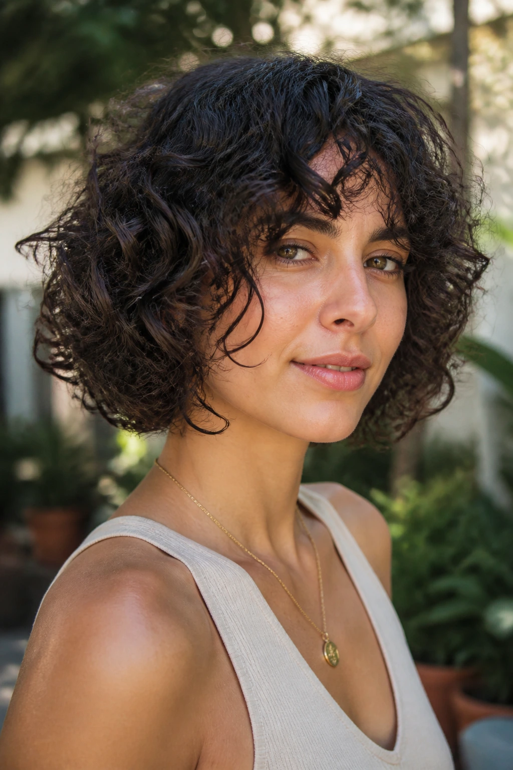 Real woman with curly point-cut bob showing defined curls