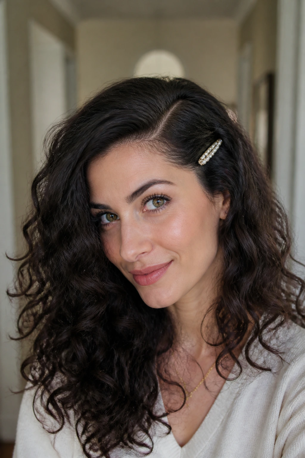 Close-up of a real woman with a deep side part and barrettes in 2B waves