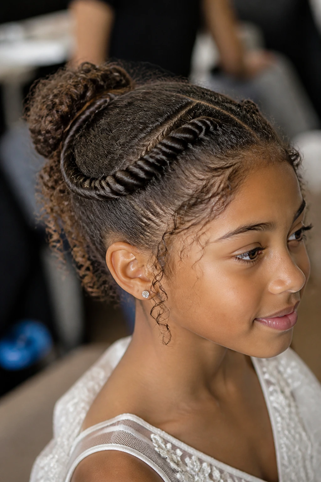 Close-up of a real child with twisted crown and small bun